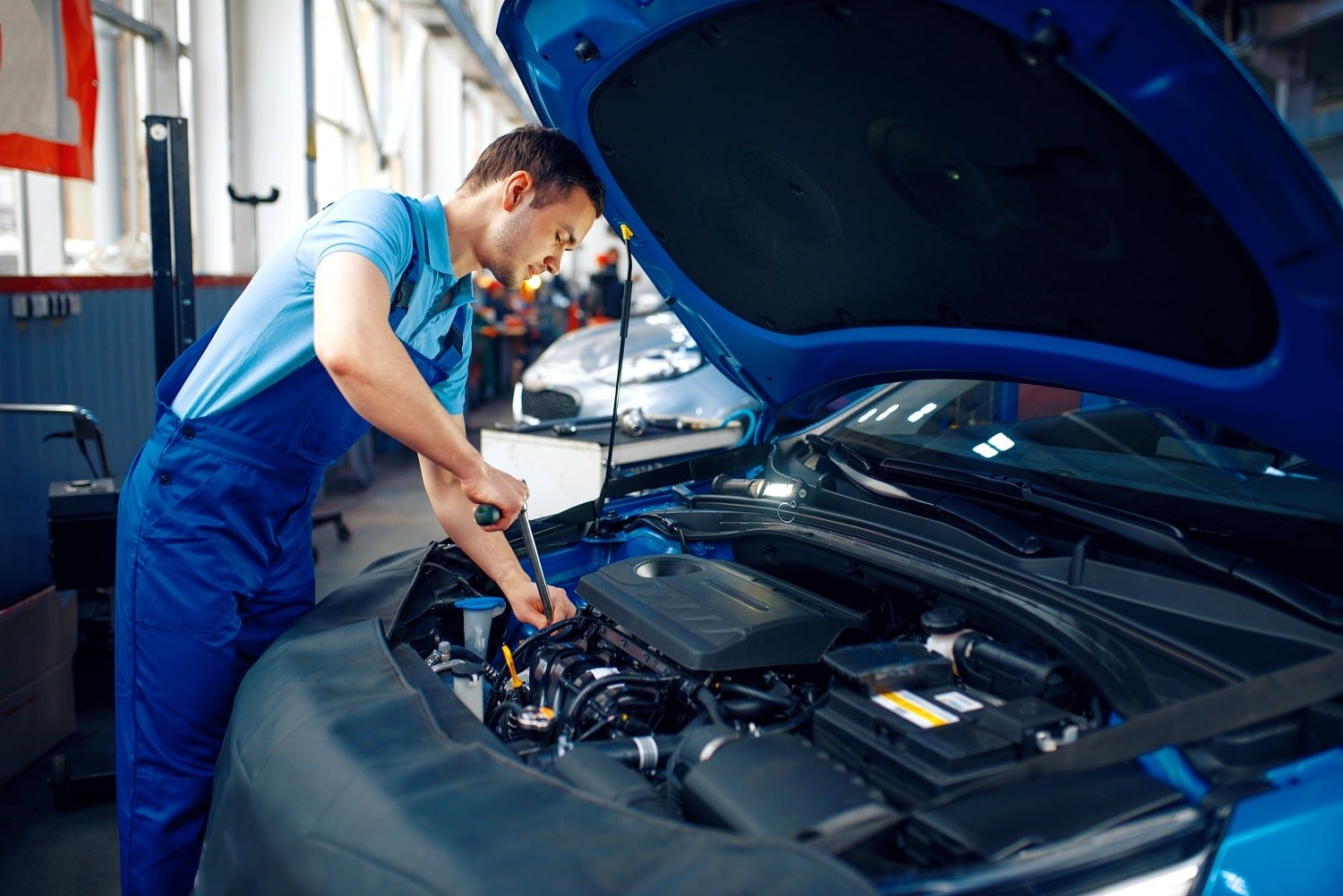 worker-in-uniform-checks-engine-car-service-2021-08-27-11-44-45-utc-min.jpg